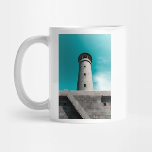 The lighthouse against blue sky Mug